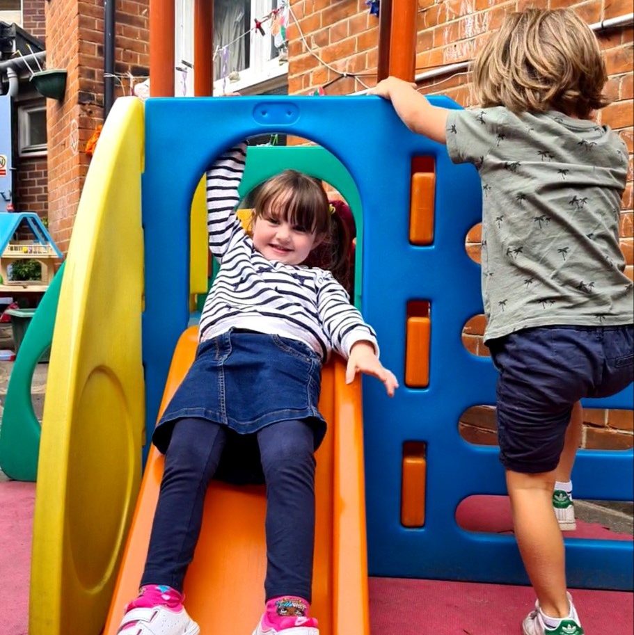 Smiling going down the slide