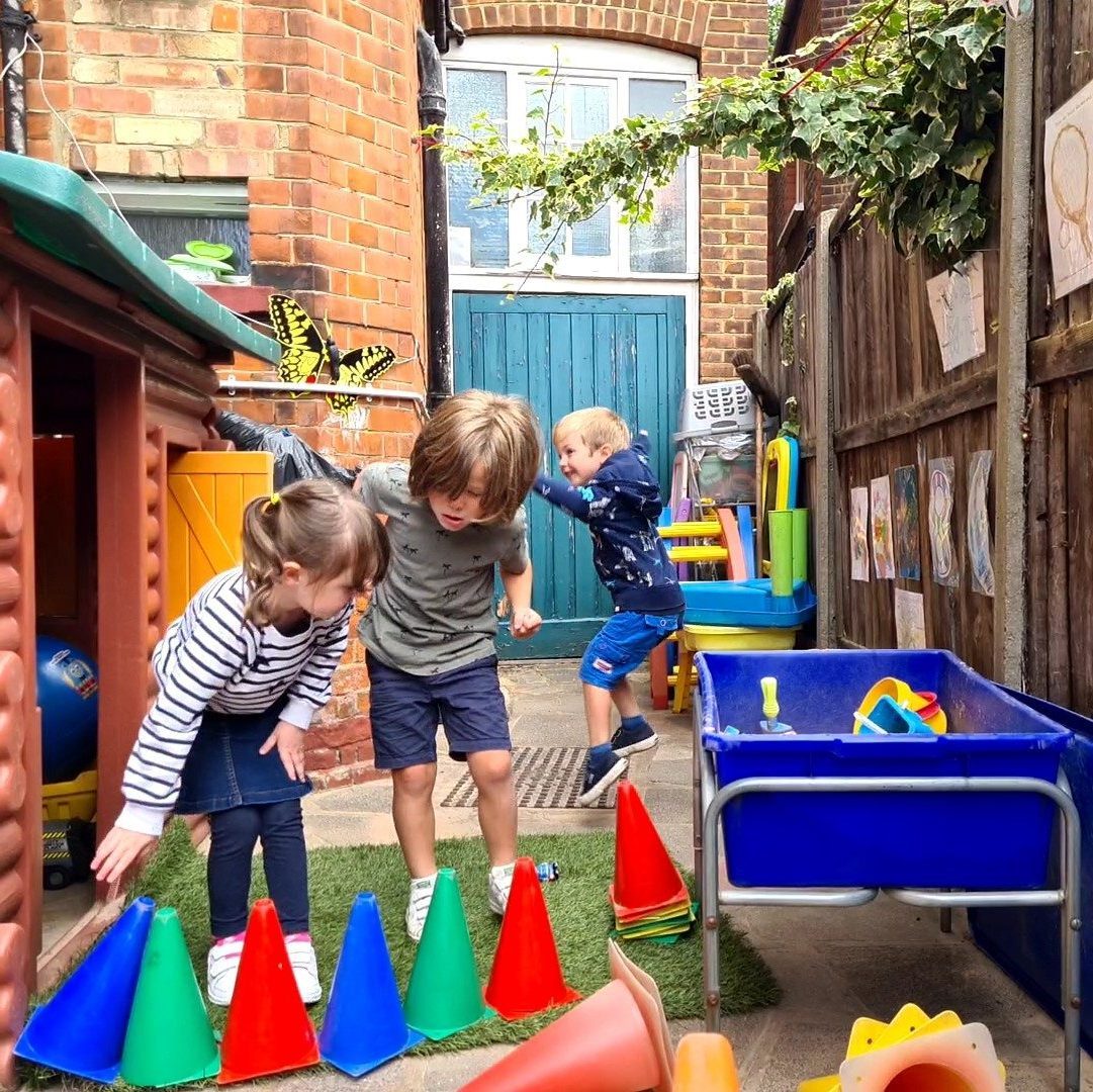 Children playing in the garden with their playhouse